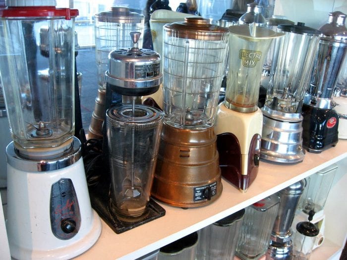 An array of blender models displayed on a shelf.