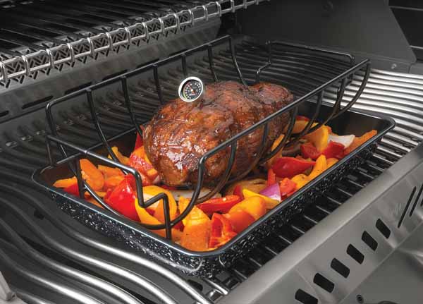 The image captures a big piece of meat grill to perfection inside a grill. It rests on a bed of vibrant red and yellow bell peppers, nestled in a grill tray that collects the succulent juices. The grill lid is open, allowing a glimpse of the grilling process in action, with the grill grates above providing additional cooking space. A built-in thermometer on the grill lid offers precision for the best grill outcome. The meat's surface glistens with a well-seared crust, a hallmark of grill expertise. This grill scene is a celebration of grilling, with the flavors melding together in the cozy confines of the grill.
