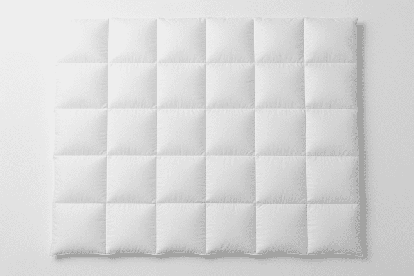 Overhead view of down comforter with precise baffle box quilting on a seamless white background.