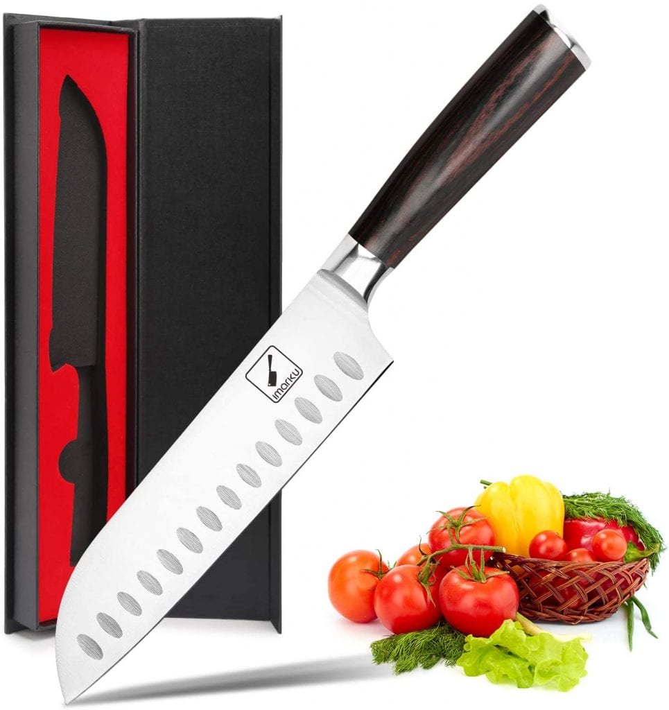 There is a chef's best knife. There is also a box made specially for that chef's best knife. There is a basket of fruits and vegetables beside the box. 