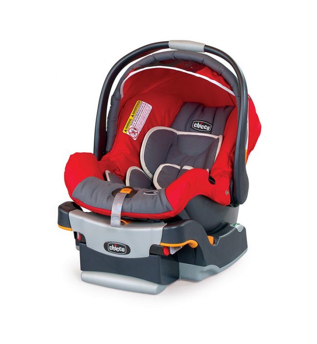 Infant car seat: A vibrant red and grey Chicco infant car seat with an adjustable sunshade and orange accented handle, displayed with its compatible grey base. Perfect infant car seat.