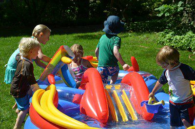 The kids are having a great time in the outdoor inflatable pool.
