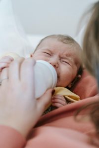 Fussy kid drinking formula