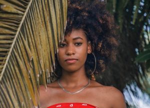 lady in red wearing unique summer earrings