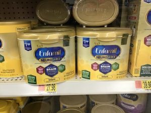 Cans and boxes of Enfamil infant formula are arranged in the grocery's shelves. This brand is among the best baby formula options. 