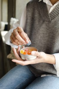 A woman taking supplements in the form of gummies for a healthy pregnancy