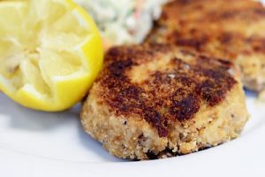 Frying and seasoning your delicious air fryer crab cake. 