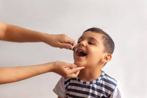 Best supplements for children development of body and bones. Here's a happy child taking his supplement in liquid form. KidslLiquid syrup is truly the ideal supplement form that children can take easily. You can convince your child right away to take it, without hesitation.