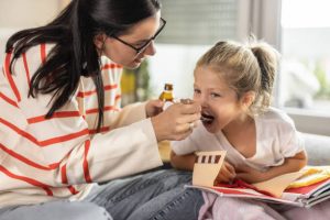 Liquid supplements for kids: kids liquid supplements. The girl child is happy taking her supplements. Her mom is also satisfied in supplementing the nutrients her body needs.