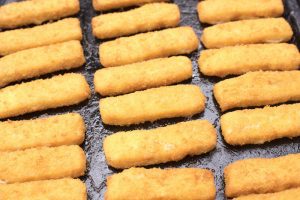 Preparing mozzarella sticks snack in an air fryer. Air cooking tips.