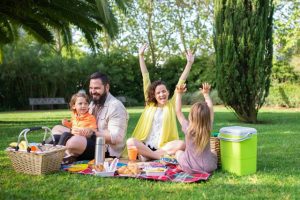 A family having fun in a picnic get together for their summer vacay. There are many different types of resting spots that you can choose from for this hot season. You can go to a beach town or city, visit a national park or art galleries, eat local cuisines, or stay home and enjoy your own backyard. There is something for everyone!