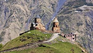 It looks like a castle located on the ledge of the mountain. 