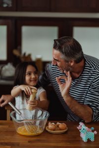 Father and daughter making egg bites.