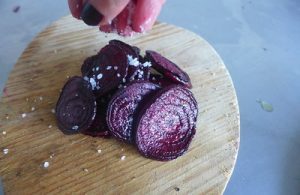 Season your beet slices to prepare them for air frying.