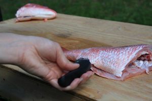 The salmon is being cut properly before putting it in the air fryer for a perfect result. 