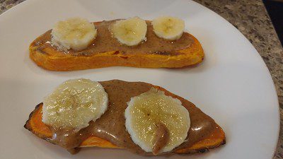 delicious sweet potato toast baked in an air fryer topped with peanut butter and banana slices served in white plate ready for eating