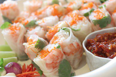 Delicious and appetizing spring rolls with dipping sauce on the side