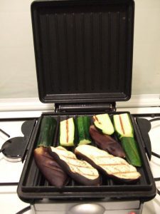 vegetables cooking on a grill plate