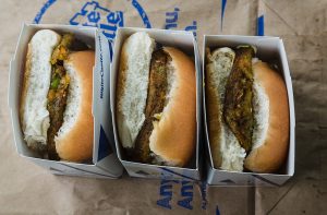 Three White Castle sliders in their signature boxes, displayed on branded paper. You can achieve this with an air fryer.