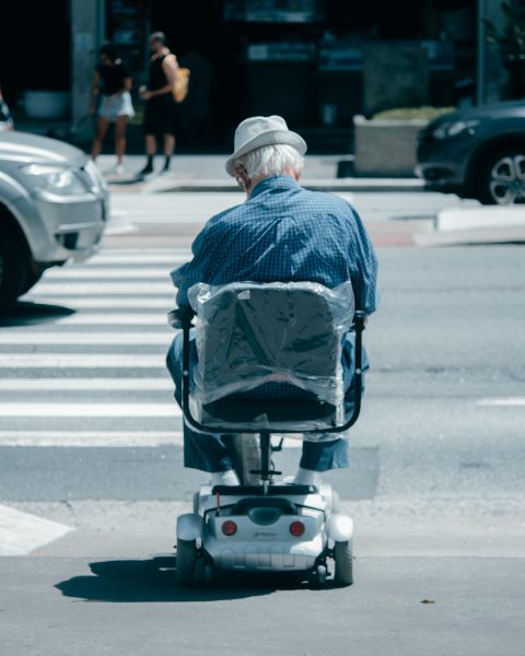 A senior is testing a scooter before buying.