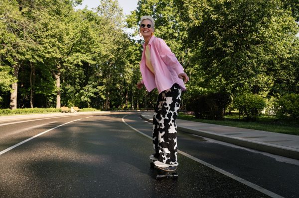 A woman without safety gear on her skateboard