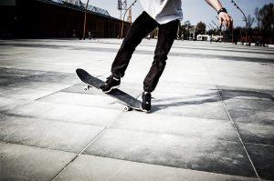 A man doing safety longboard trick.