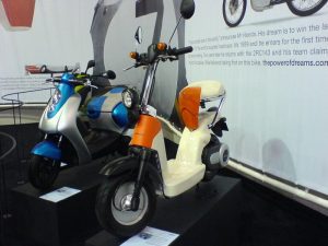 Two modern electric lightweight scooters parked side by side, showcasing sleek designs and eco-friendly mobility solutions.