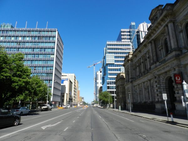 You can see a wide city streets. There are buildings there is no sign of poor traffic flow. This is a great road for your scooter. 