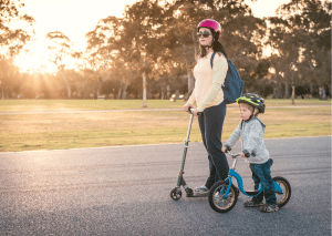 Mother and child, on a scooter adventure. Helmet-clad duo, safety wrapped in love. The scooter hums, carrying dreams and laughter. Wind tousles hair, as trust guides their path. Shared moments, handlebar held and memories made. Each push forward, a journey of discovery. Pavement unfolds stories under scooter wheels. Guardian helmet, shielding, whispers caution and courage. Joy radiates, moments etched in their hearts. Together they glide, two spirits unbound. In sync with each other, road and life. A mother's embrace, a kid's unfiltered glee. Scooter and helmet, vessels of togetherness.