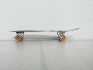 A cruiser skateboard on the floor.