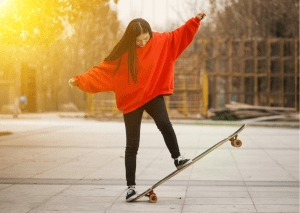 woman in red on a board trying to do some tricks 