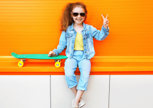 Review girl skateboards online little one holding out a peace sign