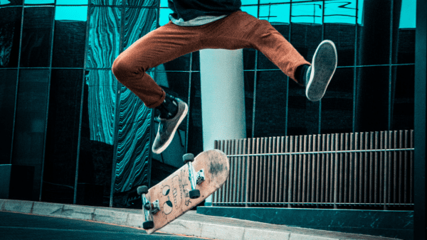 An expert skateboarder doing skateboard stunts, practicing these tricks on the rough concrete