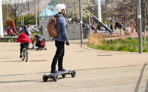  schooling-aged young boy riding a skateboard