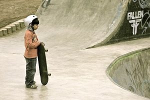 a little kid getting ready to skateboard