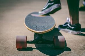  Foot of a person resting on a longboard.