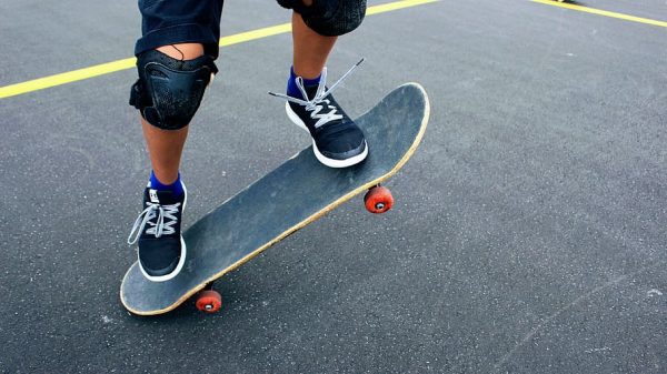 Someone on a skateboard wearing skate pads