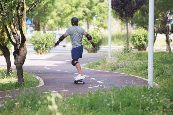 Skateboarding Pads: A man skateboarding while wearing protective skating equipment and skate pads. Wearing skate pads while riding is very important for your safety. Skate pads are the best way to stay safe on a skateboard.