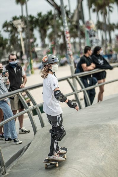 Skateboarding Pads: A skateboarder wearing protective skate gear at the skatepark. All skateboarders should invest in good protective padding and skate gear. Even experienced skateboarders need good skateboarding pads and skate gears.