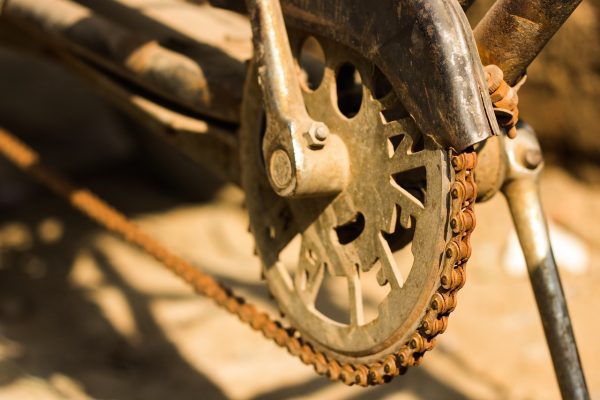 Rusty scooter chain like it needed to be cleaned.