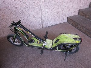 A sleek green foldable scooter with a lightweight aluminum frame