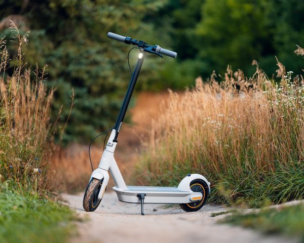 An electric scooter standing on a dirt road