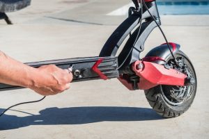 Man charging electric scooter