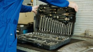 A scooter mechanic preparing tools.