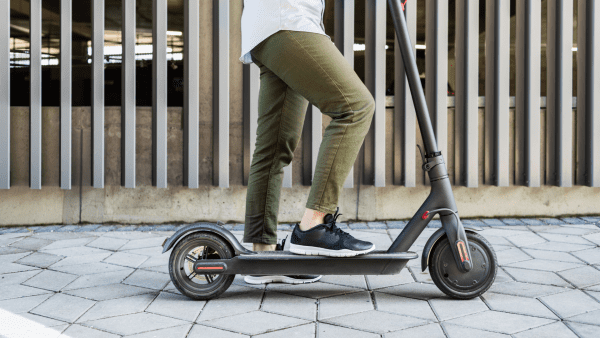 A man riding a scooter safely. 