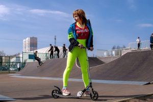 Woman preparing scooter tricks