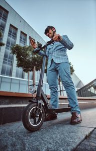 A college student is enjoying a fun and safe ride after proper scooter bearing maintenance. This is an example of taking proper care of your scooter.