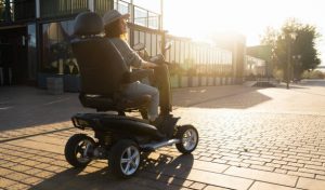 a person can be seen using a mobility scooter for good body rehabilitation