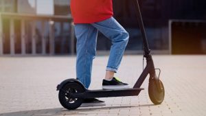 A teenager riding a scooter for a fun scooting