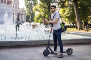 Scooter Models For Adventure: Man with his adventure scooter.